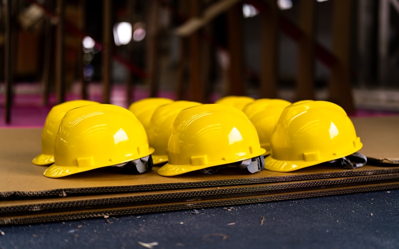 Row of yellow safety helmets ready for issue on site